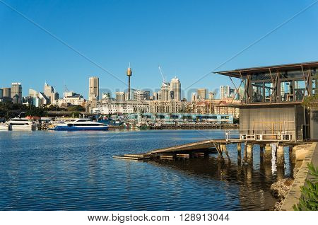 Sydney city view of boat house Sydney Fish Market Glebe and CBD with Sydney Tower Centrepoint as viewed from Blackwattle bay. Office commercial and residential skyscraper buildings