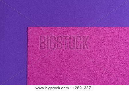 Eva foam ethylene vinyl acetate sponge plush pink surface on purple smooth background