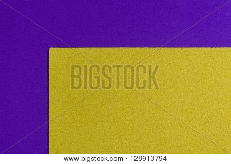 Eva foam ethylene vinyl acetate sponge plush lemon yellow surface on purple smooth background