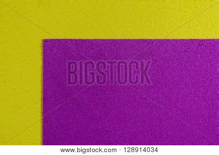 Eva foam ethylene vinyl acetate pink surface on lemon yellow sponge plush background