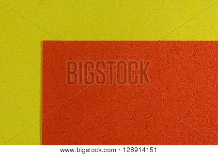 Eva foam ethylene vinyl acetate orange surface on lemon yellow sponge plush background
