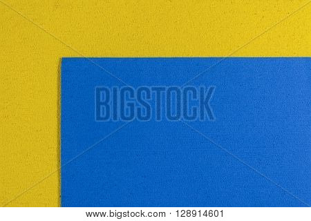 Eva foam ethylene vinyl acetate blue surface on lemon yellow sponge plush background