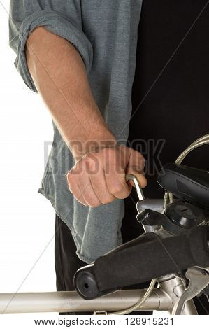 Man repairing bicycle handlebar over white background