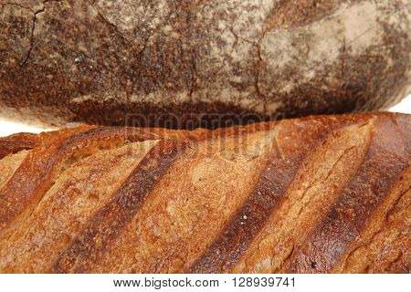 different rye and white flour fresh french bread loaf isolated on white background