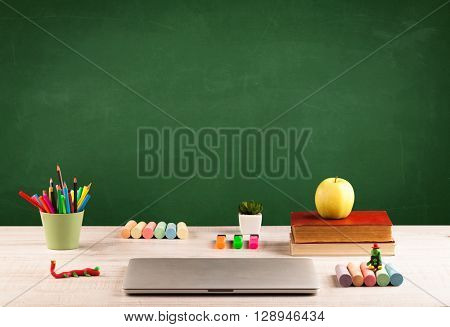 Back to school concepty with clear blackboard background, desk, items