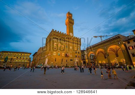 FLORENCE, ITALY - JUNE 12, 2015: Night is comming in the center of Florencia, Old Palace in the middle of square.