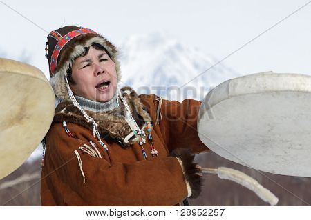 KAMCHATKA PENINSULA RUSSIA - FEB 5 2012: Woman in Koryak national dress dancing with a tambourine and singing. Public concert Koryak National Folk Dance Group. Eurasia Russian Far East Kamchatka Region.