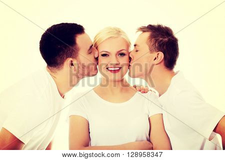 Two guys kissing friend woman cheeks