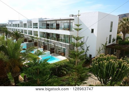 HERAKLION CRETE GREECE - MAY 13 2014: The blue sky modern building of villa with balcones swimming-pool and palms on the terrain of luxury class hotel Grecotel Amirandes on the Mediterranean coast of Crete May, 13 2014, Greece.