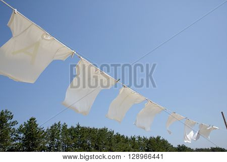 White t-shirts hanging to dry on a clothesline