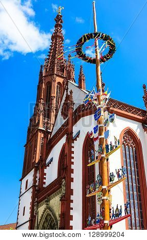 WUERZBURG, GERMANY-MAY 05, 2016: Traditional Franconian maypole in front of the Marienkapelle (built 1377-1489) in Wuerzburg, Bavaria, Germany