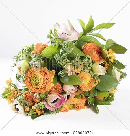 A Wedding Bouquet Of Buttercups, Anemones And Ruscus On The White Background