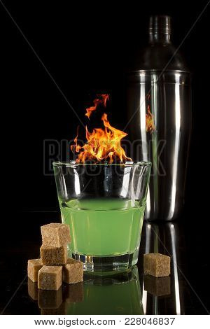 A Glass With Absinth On A Black Reflecting Surface