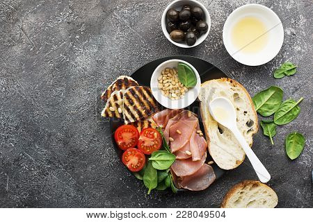 Appetizing Snack With Fried Cheese Haloumi, Olives, Bruschetta, Tomatoes, Olives, Pine Nuts, Prosciu