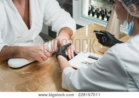 The Manicure Master During Treatmet Procedure. Patient On Medical Pedicure Procedure, Visiting Podia