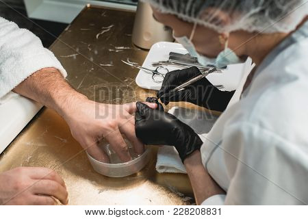 First Steps. Cropped Shot Of A Salon Client Holding Her Hand In A Bowl Of Water Preparing For The Ma