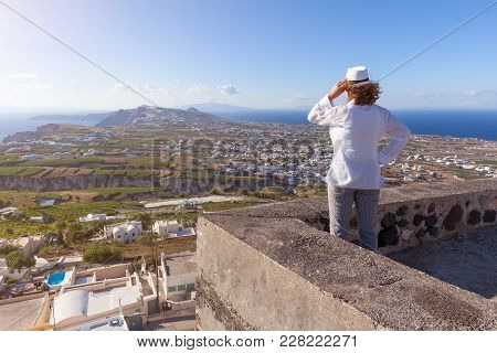 Young Redhead Woman Satnding And Watching The Traditional Villages At Sunny Windy Day. Lifestyle And