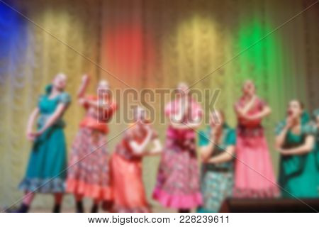 Folk Dances Of Children And Teens Theme Abstract Blur Background With Bokeh Effect. Teens In Bright 