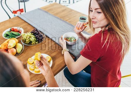 Beautiful Fit Women Eating Healthy Salad In Kitchen