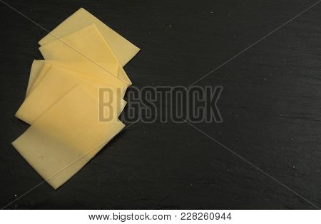 Sliced Cheese Over Stone Background