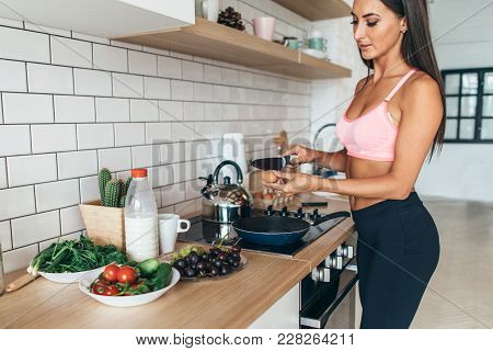 Woman Breaking Egg Separating Yolk And Egg White.