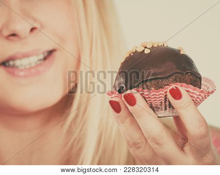 Diet, Sweets, Food Concept. Woman Holding Delicious Chocolate Cupcake With Peanut Frosting About To 