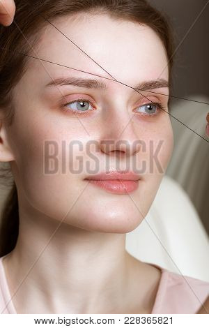 Permanent Microblasting Tattooing Freckles To A Woman In A Beauty Salon.