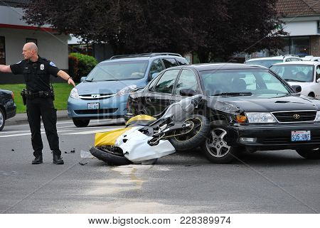 SEATTLE, WA. JUNE 12, 2008. CIRCA: Car runs into motorcycle trying to make a left turn on the road i