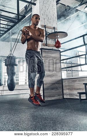 Sport Is The Way Of His Life. Full Length Of Young African Man In Sport Clothing Skipping Rope While