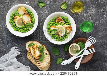 Green Young Peas, Cheese Haloumi, Lemon. Orange Salad With Slices Of Bread. Top View.