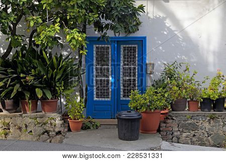 Vintage Blue Door In White Old House With Flowerpots In Kakopetria Village, Cyprus
