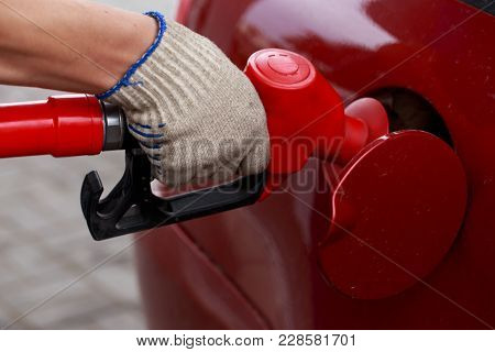 Car Fill With Gasoline At A Gas Station