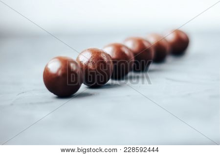 Line Of Chocolate Balls Bon Bon On Concrete Grey Background