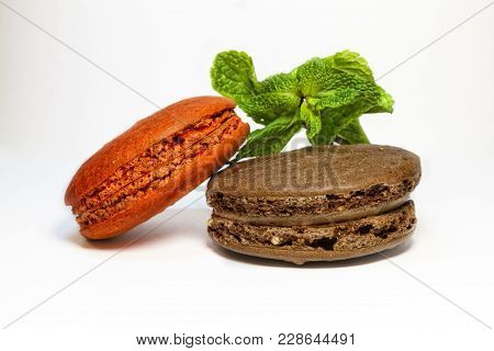 Colorful Macaroon Cookies Red And Brown With Mint Leaf On White Background