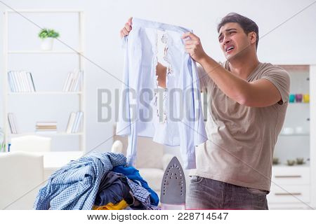 Inattentive husband burning clothing while ironing