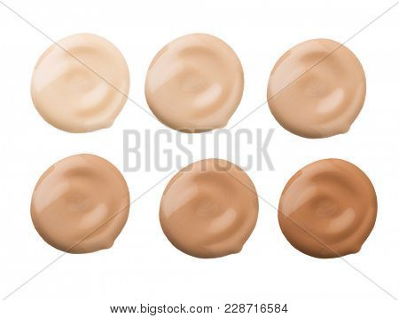 Foundation face make-up samples. Set of cosmetic liquid foundation or cream in different colour smudge smear strokes. Make up smears isolated on a white background. Foundation colors palette