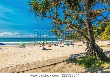 NOOSA, AUSTRALIA, FEB 17 2018: People enjoying summer at Noosa main beach - a famous tourist destination in Queensland, Australia.