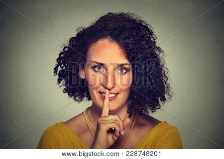 Closeup Portrait Happy Young Woman Placing Finger On Lips Asking Shhhhh, Quiet, Silence Isolated On 