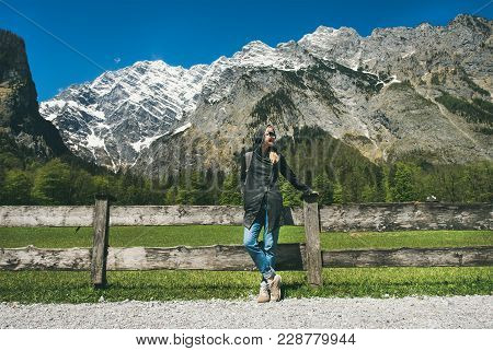 Relaxed Female Traveller Posing In Front Of Mountain View Enjoying The Alps In Austria. Freedom Conc