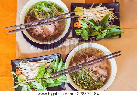 Pho Bo - Vietnamese Fresh Rice Noodle Soup With Beef, Herbs And Chili. Vietnam's National Dish