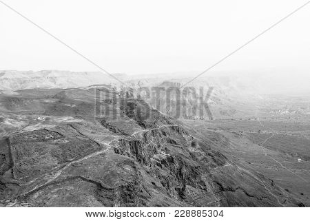Black And White Picture Of The Mountains And Desert During Sunrise In Massada, Israel