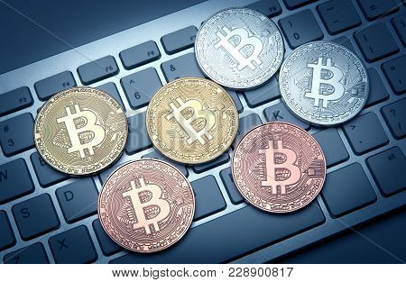 Six Coins Of Bitcoin On White Laptop Pc Keyboard Closeup