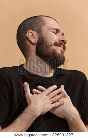 Young Casual Man Smiling And Enjoying. Smile. Emotional Man Smiling And Enjoying On Pastel Studio Ba