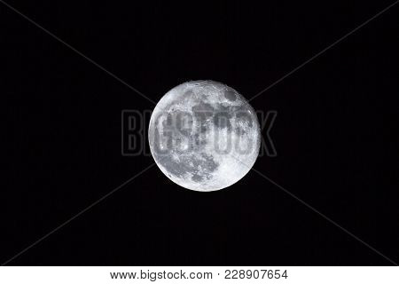Full Moon Over Dark Black Sky Background At Night. Lunar Perigee Super Moon Coincidence Of A Full Mo