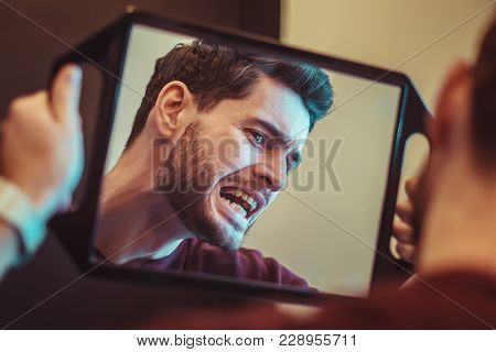 Young Man Checking Their Teeth At Mirror After Dental Treatment - People Bodycare And Stomatology Co