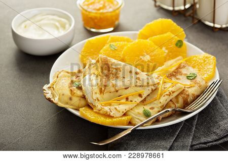 Crepes Suzette With Cream Cheese Filling, Orange Sauce And Fresh Oranges