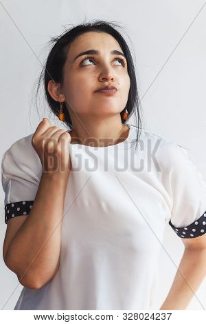 Portrait Of A Pretty Confident Woman, Holding Hand Near The Face, Looking Upwards With Thoughtful Fa