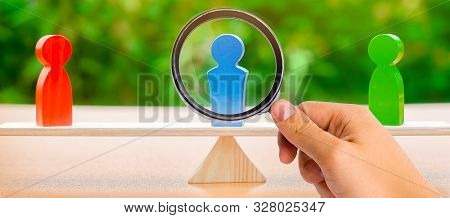 Wooden Figures Of People On Scales And A Mediator / Arbitrator. Conflict Of Interest. Resolving Conf