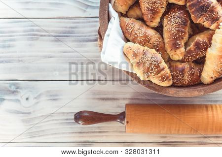 Crescent Rolls On The Wooden Table With Dough Roller. Homemade Croissants.