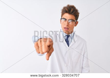 Young handsome sciencist man wearing glasses and coat over isolated white background pointing displeased and frustrated to the camera, angry and furious with you